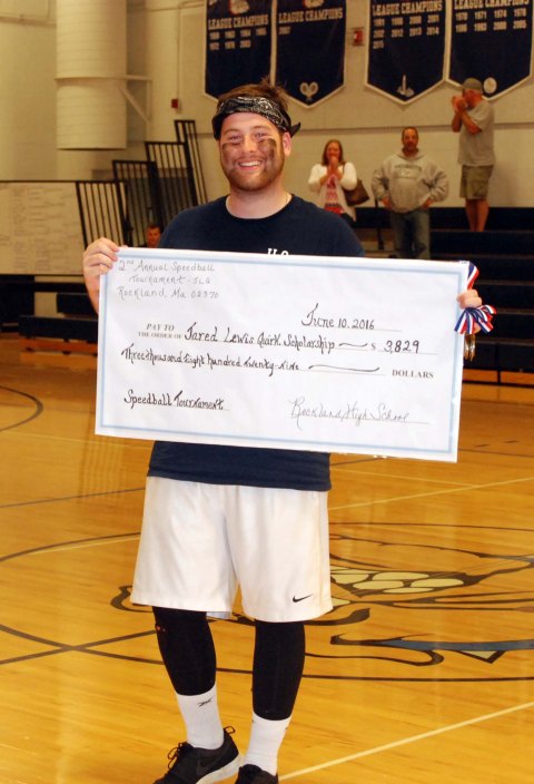 Ryan Quirk holds a copy of the check for $3,800 dollars raised for his brother, Jared's Memorial Scholarship Fund at the second annual speedball tournament on June 8-10. photo by Hannah Boben