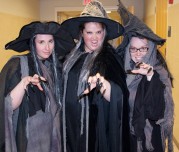 Mrs. Shaugnessy, Ms. White and Ms. Fagan casting a spell in their witchy robes.