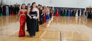the line of prom goers progresses through the arch