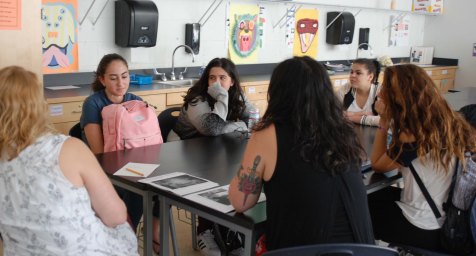 Mrs. Thompson and Ms. Medeiros lead a small group discussion about the NY Times Arts section. Veritas Photo.