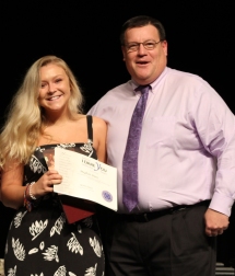 Meghan Dion received the National Leadership "I Dare You" Award from Dean Fredrick Damon